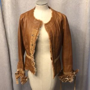 Gorgeous Cache 100% lamb leather jacket. The inside is polyester and lamb fur.